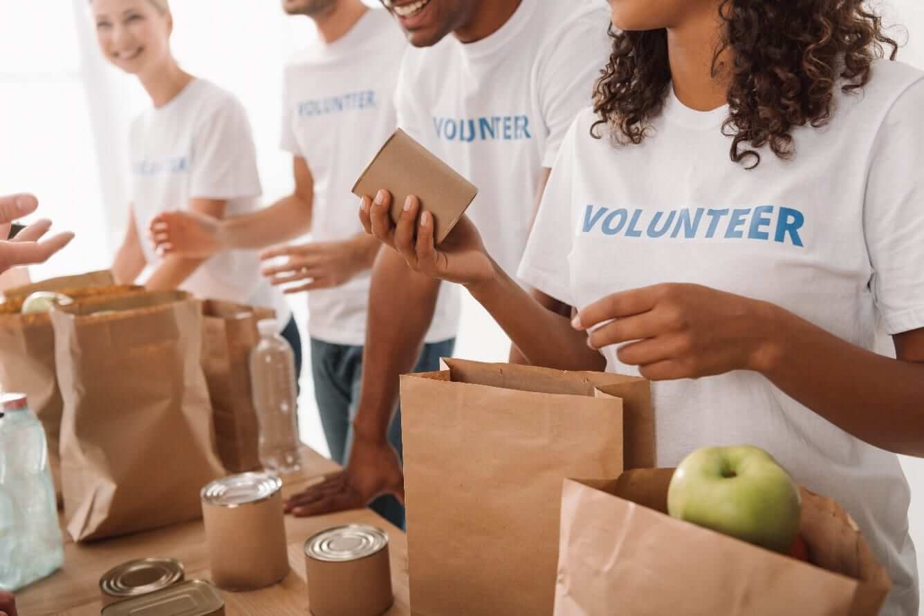 Volunteers packing groceries together